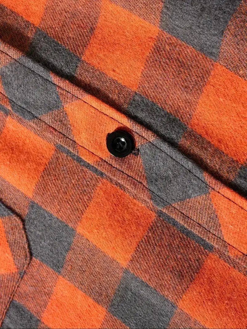 A black button on a men’s plaid hooded flannel shirt with an orange and gray plaid pattern.