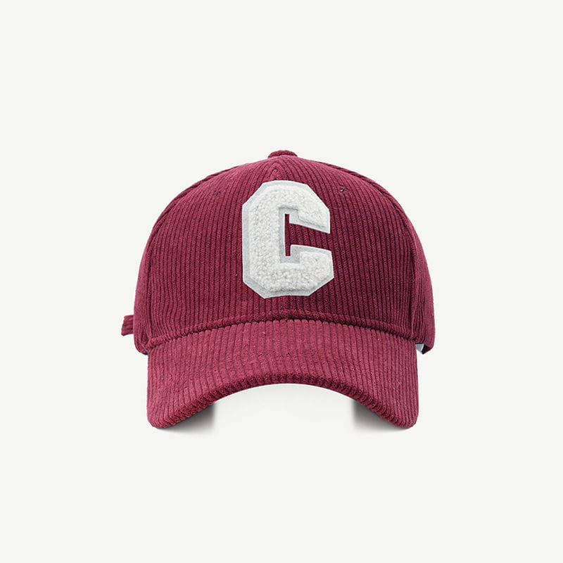 Maroon corduroy baseball cap featuring a white embroidered letter c on the front.