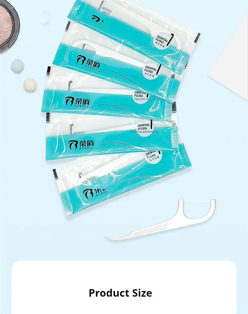 White plastic dental floss pick with a sleek ergonomic design and teal-colored packaging featuring the brand name koroll and dental floss picks 100 count individual packets.