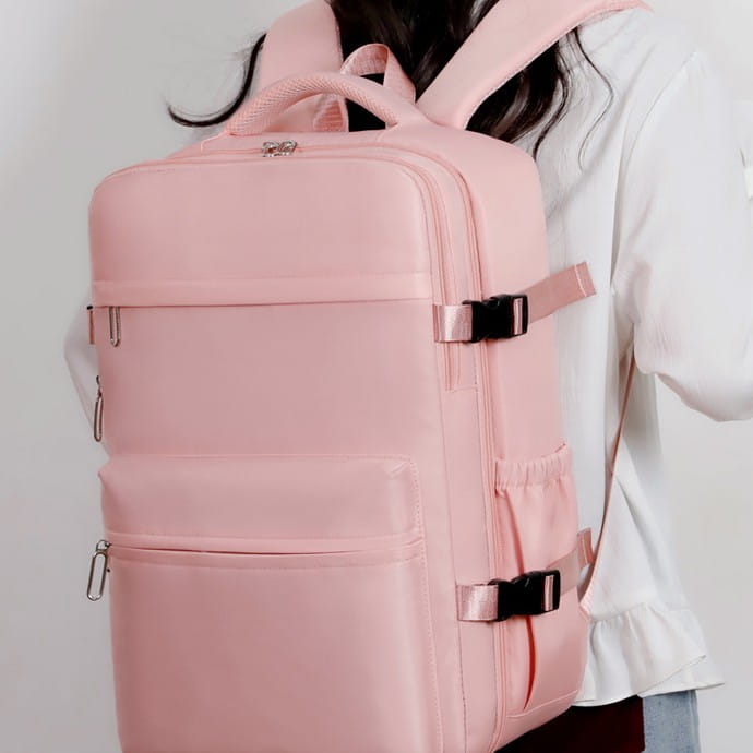 Mochila acolchada rosa para laptop con compresión al vacío de 15 pulgadas y 35 L, con diseño estructurado, múltiples compartimentos con cremallera y correas ajustables.