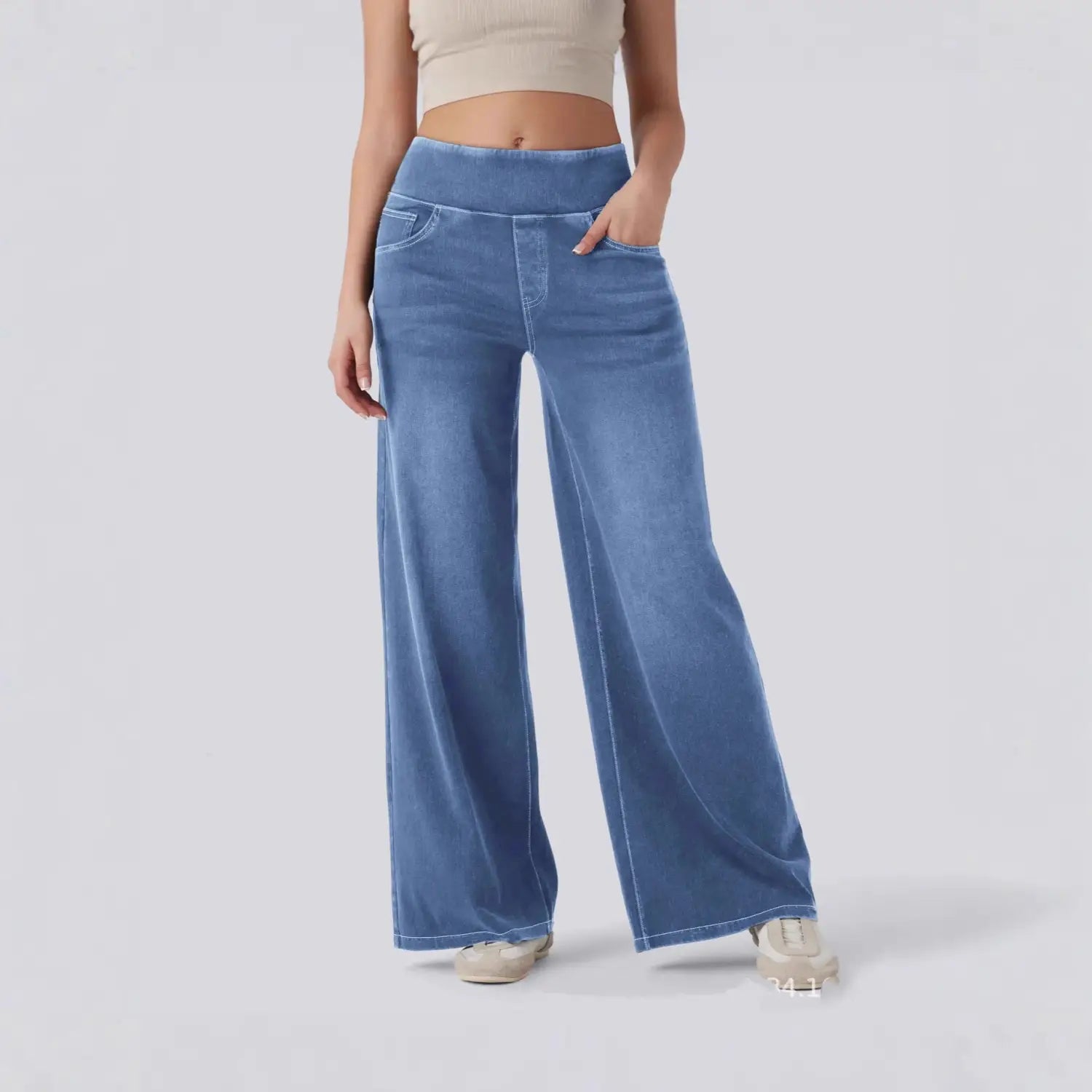 Jeans en denim à jambes larges taille haute bleus présentant un pantalon en denim bleu à jambes larges, taille haute et léger effet délavé.