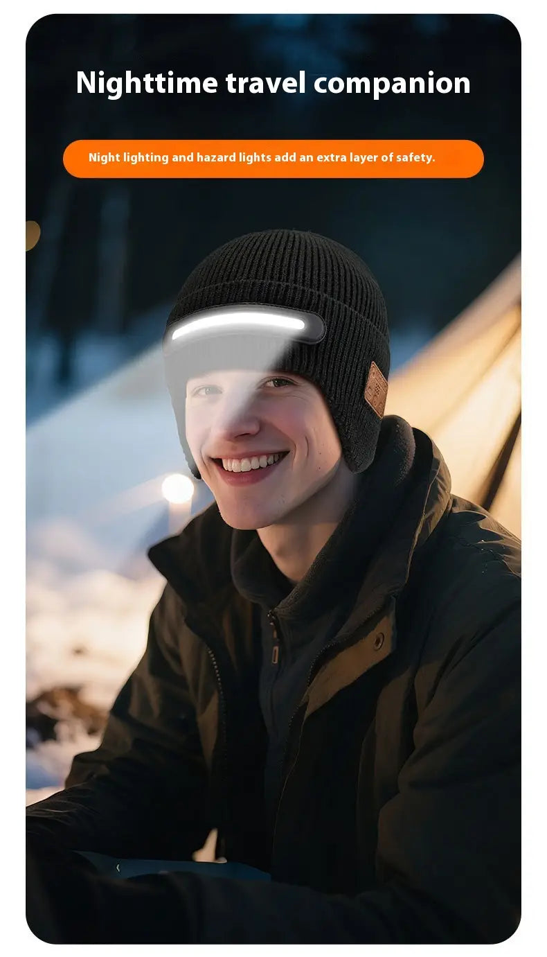 Black knitted beanie hat with integrated white led headlamp strip designed for running with bluetooth connectivity.