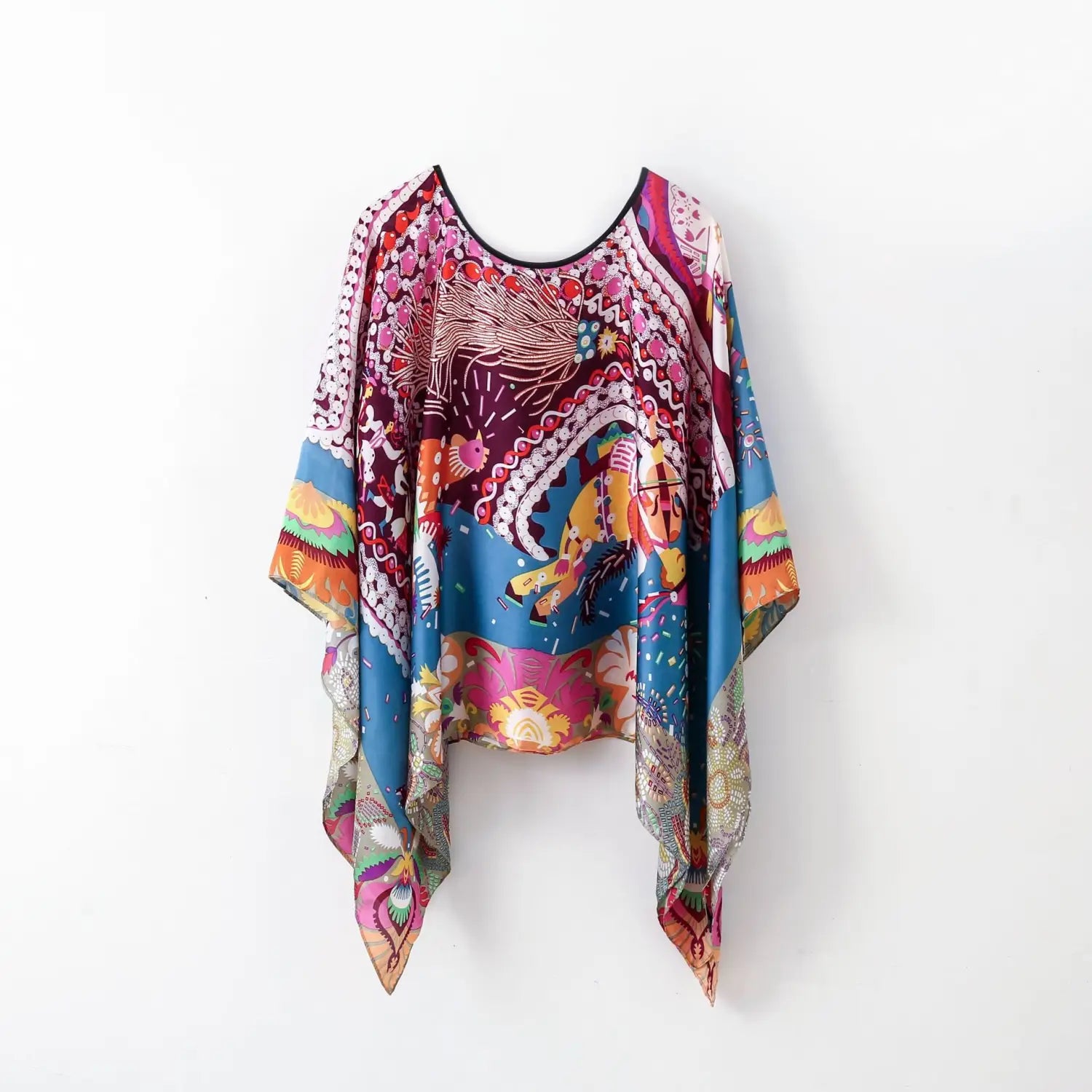 Printed silk patterned pullover shawl cape outerwear in vibrant flowing colors with intricate designs.