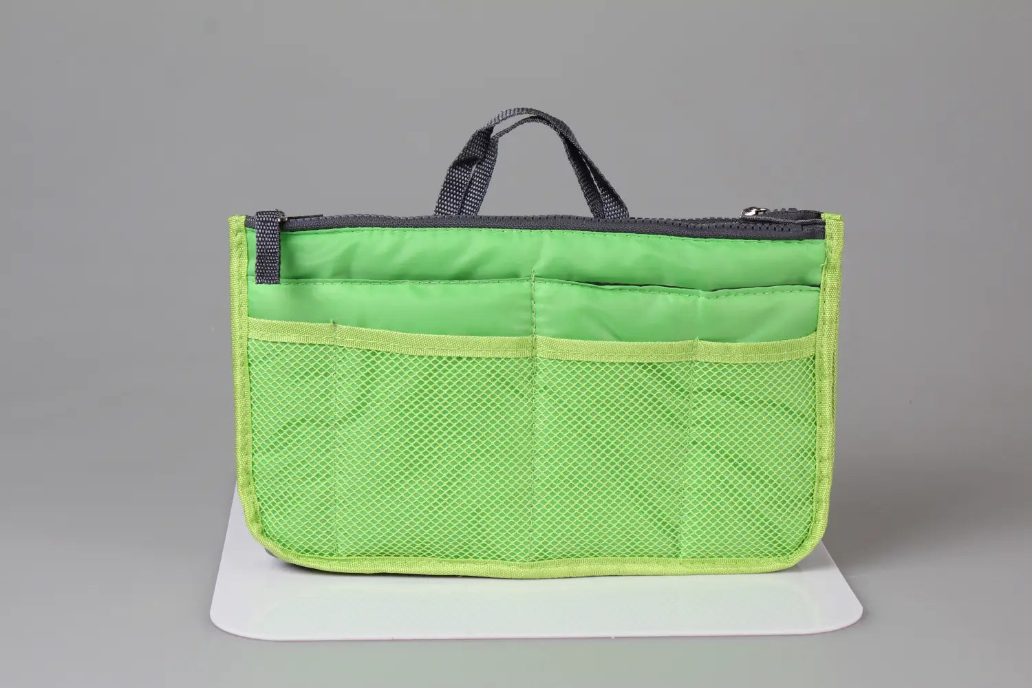 Bright lime green mesh multi-pocket nylon handbag organizer with black dual zippers and handles.