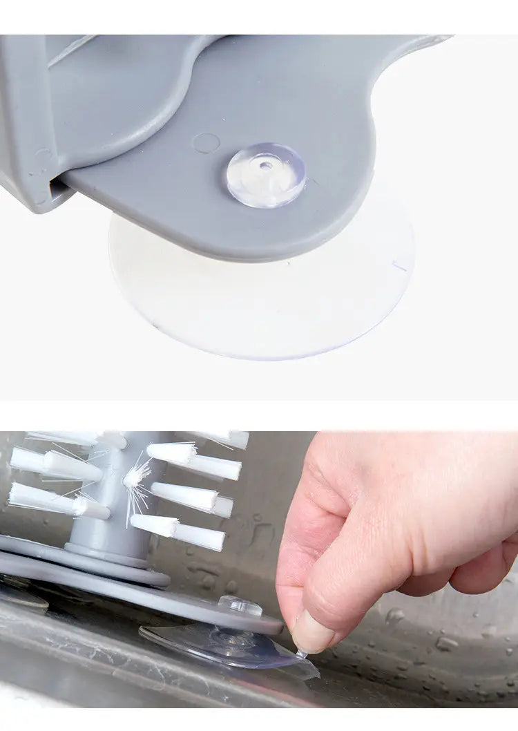 Gray plastic glass cleaning brush with white bristles and a suction cup base for sink scrubbing and easy storage.