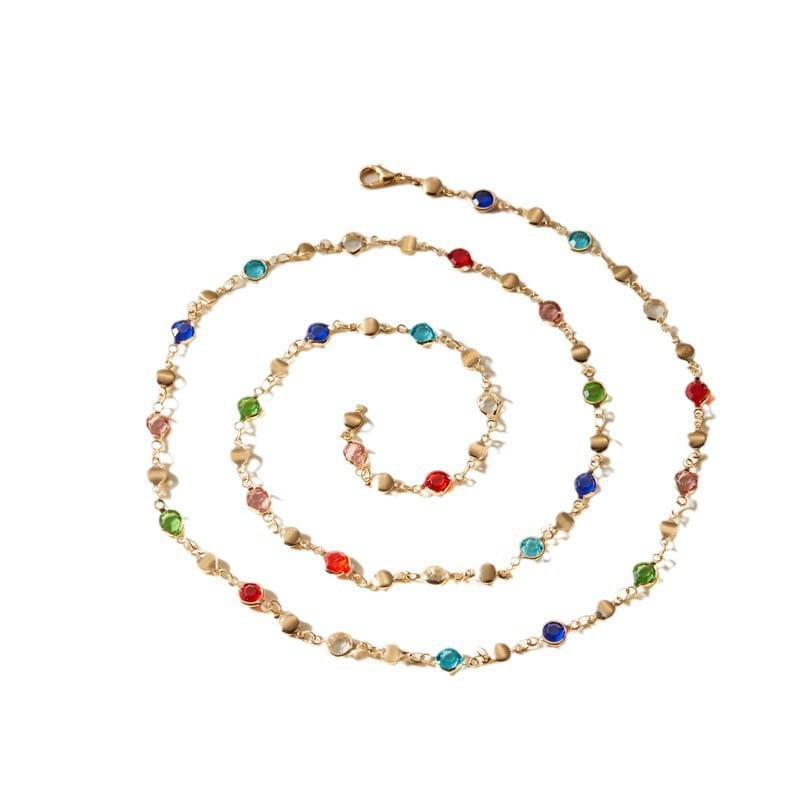 A delicate gold-toned necklace featuring a spiral arrangement of colorful faceted gemstones in red blue green and teal called multicolor crystal geometric gold pendant necklace.