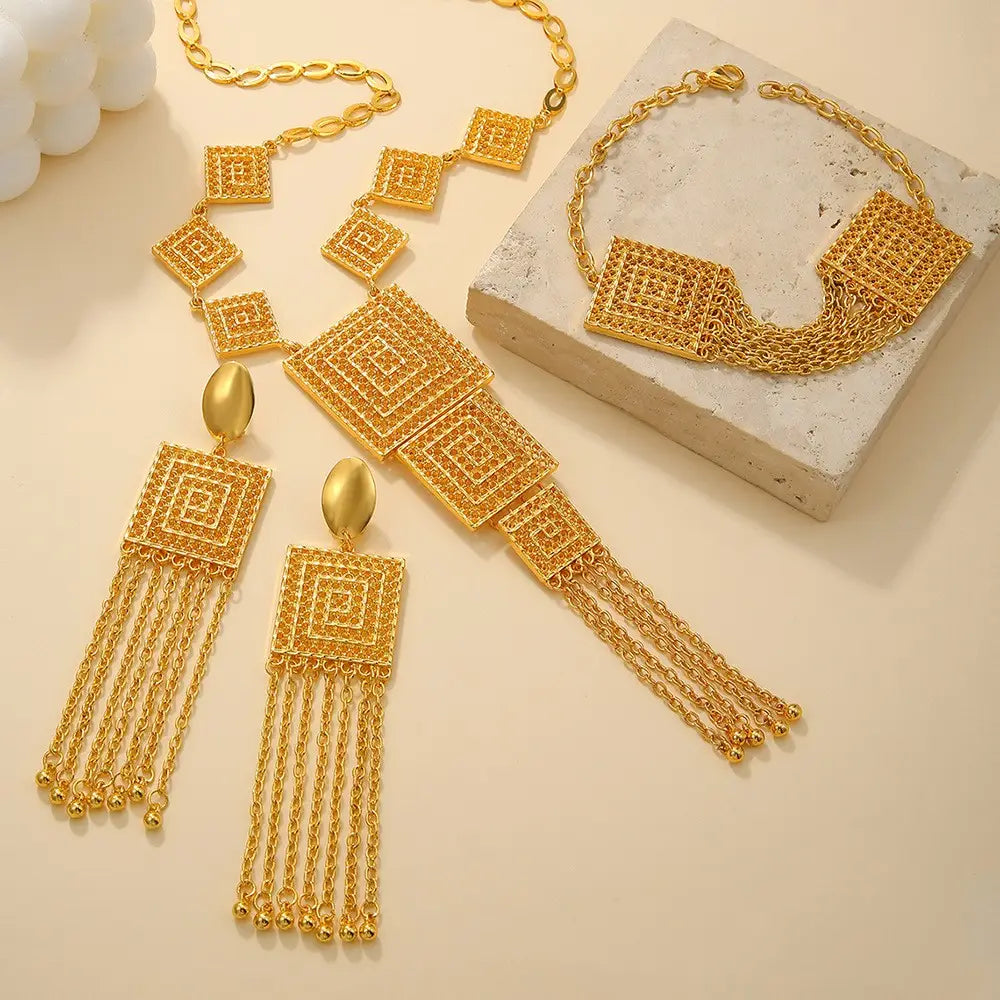 gold layered tassel necklace and jewelry set featuring a gold-toned geometric design with intricate square patterns and dangling chain tassels