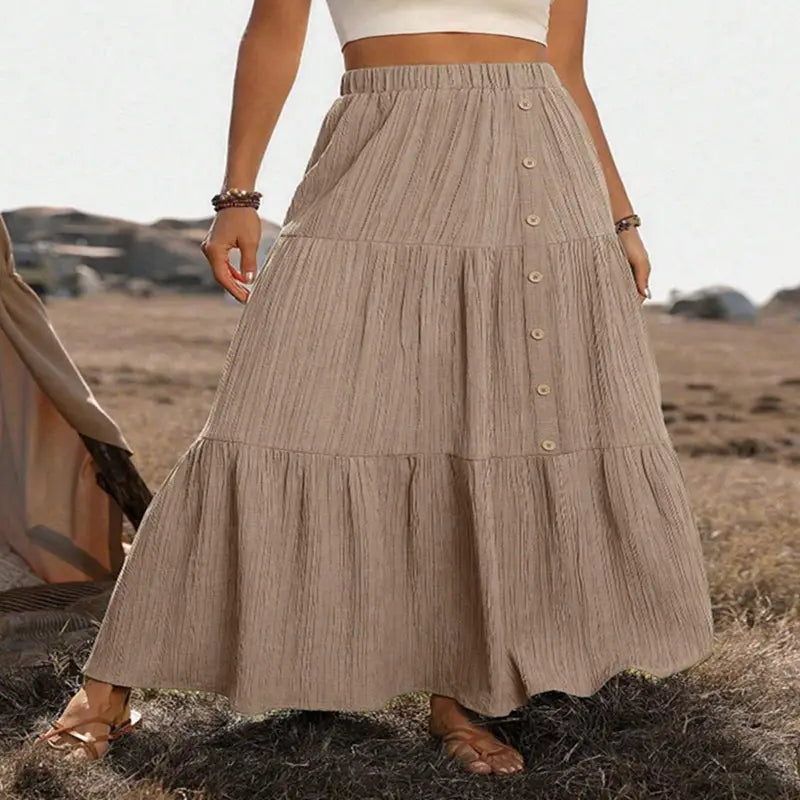 Beige tiered maxi skirt with lightweight textured fabric and button detailing down the front for casual wear.