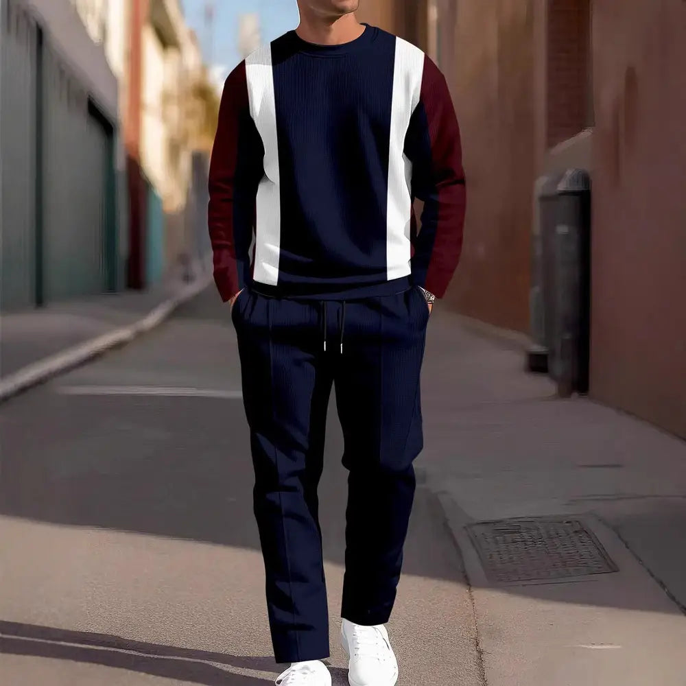 Sweat-shirt en maille bleu marine et bordeaux, avec empiècements contrastés, doté de rayures verticales blanches, présenté dans l’ensemble deux pièces décontracté et sport pour homme, sweat-shirt et pantalon.