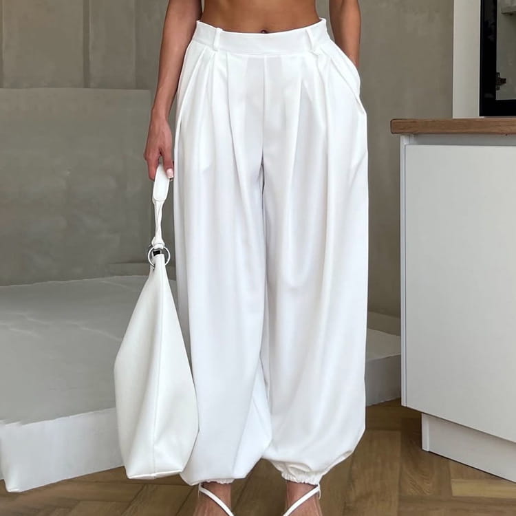 white high waisted balloon jogger pants featuring pleated detailing, a loose balloon silhouette, and elastic cuffs.