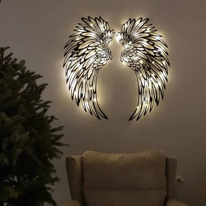 Angel wings metal wall art with led lights featuring illuminated metal wings with intricate feather detailing and warm backlighting.