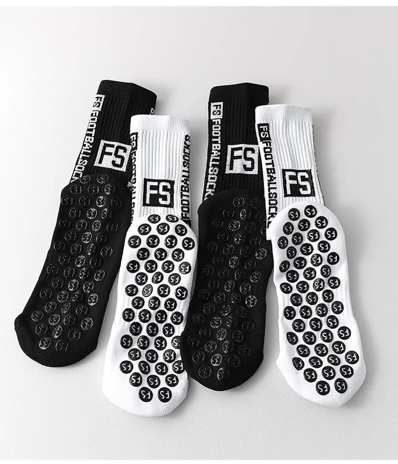 Black and white anti-slip football grip socks for men showing the textured circular pattern on the soles.