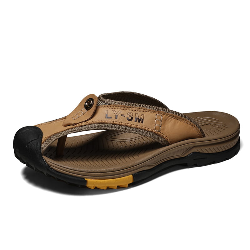 Men’s leather beach sandals outdoor sport flip flops featuring tan leather flip flop with black rubber sole and yellow accent on the heel viewed from the back side.