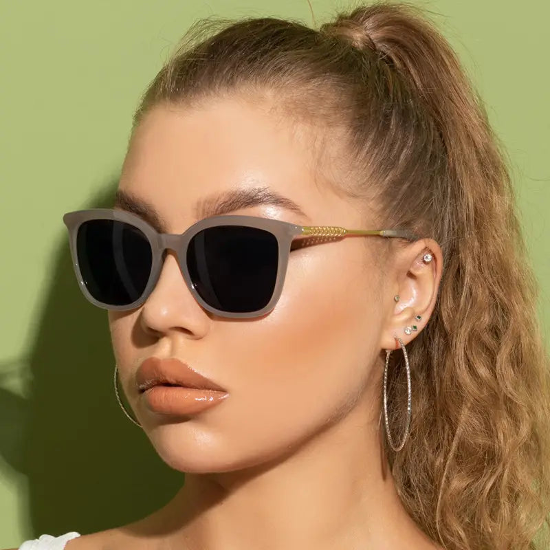 Gray vintage cat eye sunglasses with gold-tone temple details and dark lenses.