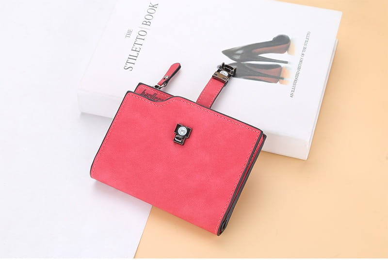A vibrant red suede women’s short faux leather multi slot wallet with a sleek black metal clasp and matching strap.