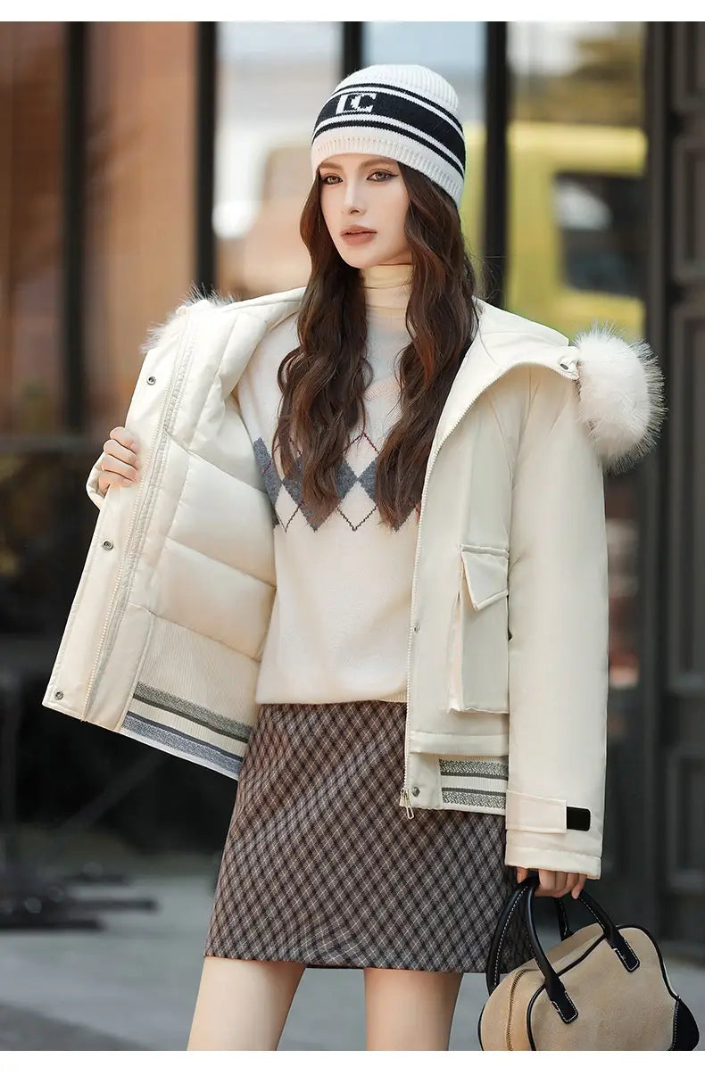 Cream-colored faux fur collar puffer jacket with a fluffy white fur-lined hood and striped detailing on the cuffs.