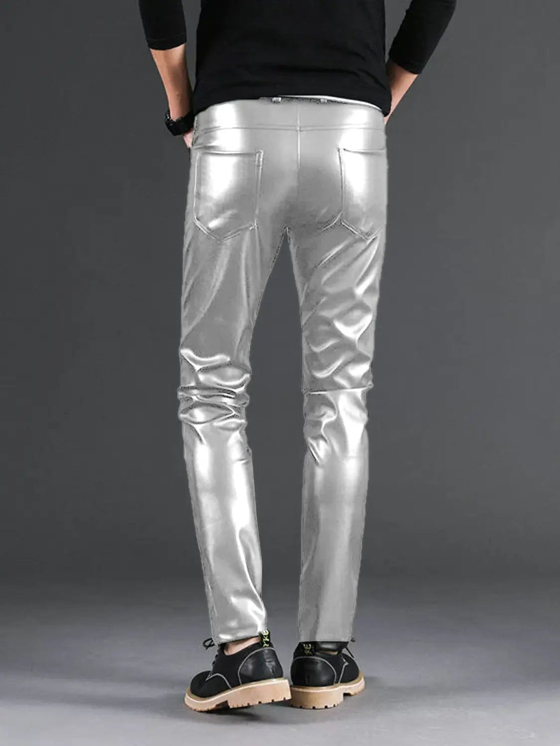 Men’s slim fit metallic and matte faux leather pants in shiny silver with visible stitching details.