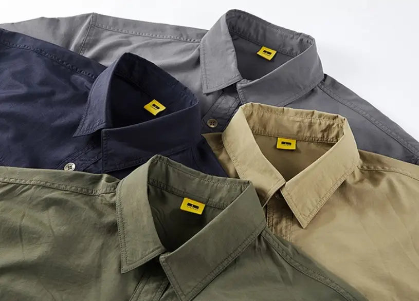 A collection of men solid workwear short sleeve button-down shirts in navy gray khaki and olive green colors.
