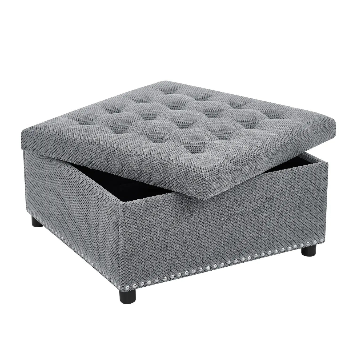 Gray tufted storage ottoman with a textured fabric finish and decorative nailhead trim along the base for stylish organization and seating.