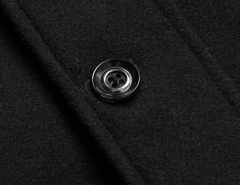 A sleek silver-toned four-hole button on textured black wool fabric of a men wool winter overcoat quilted jacket.