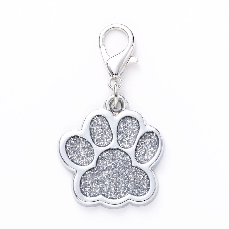 Silver glitter paw print charm featuring a polished metal clasp in a glitter paw print metal dog tag design.