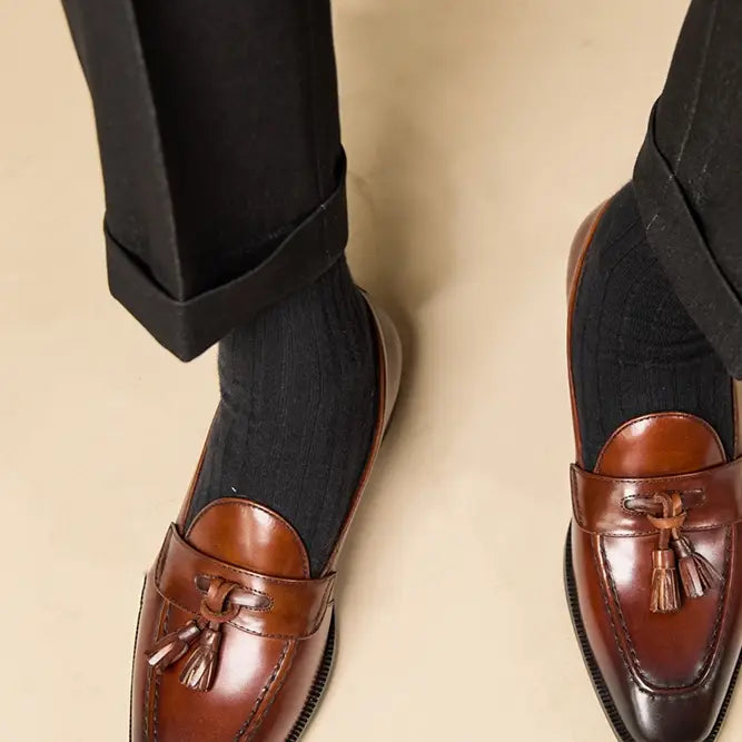 polished genuine leather tassel loafers in black patent leather with a glossy finish and classic design