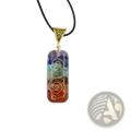 A rectangular 7 chakra pendant necklace with layered rainbow resin, natural stones, and gold-toned wire filigree design