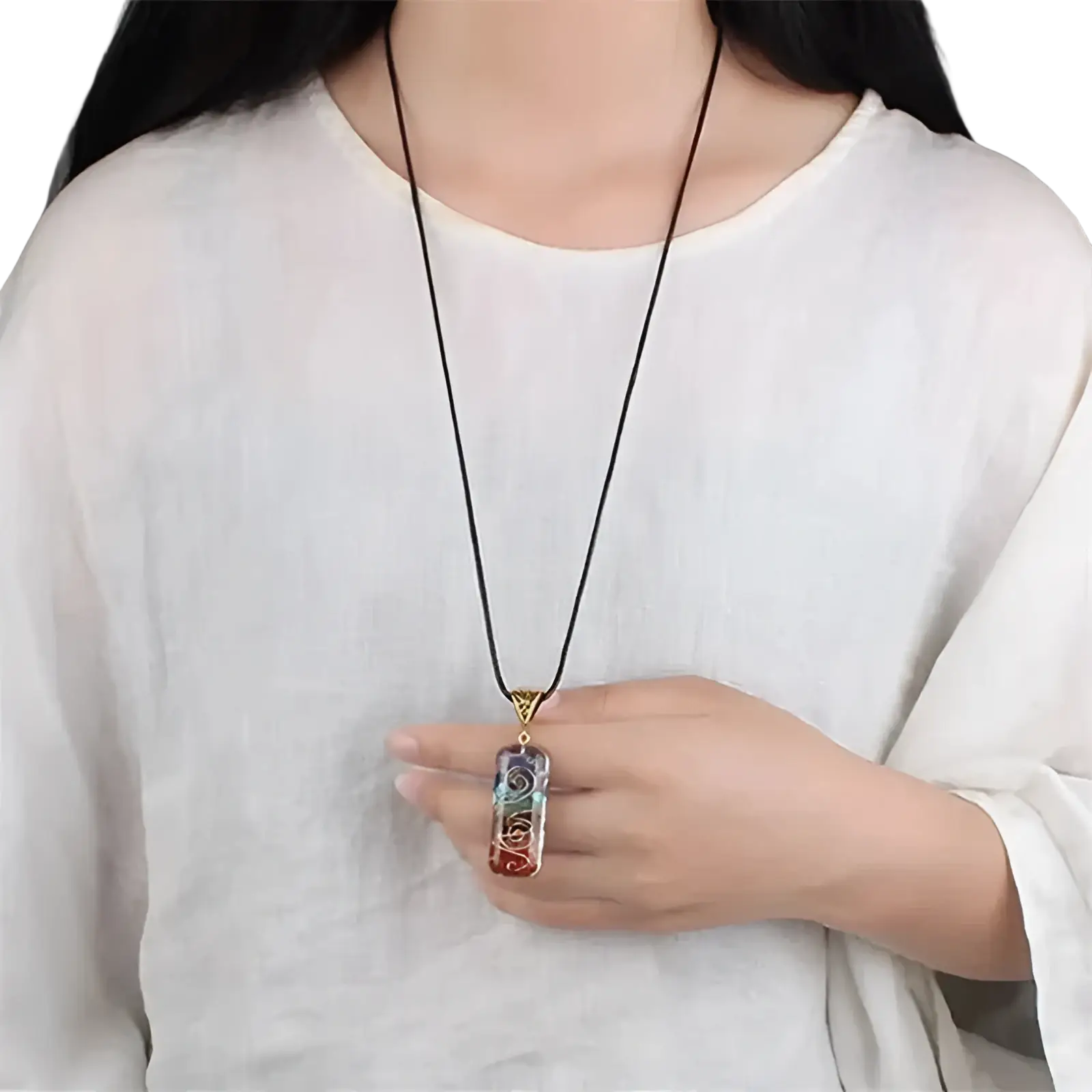A rectangular rainbow-colored 7 chakra natural stone filigree healing pendant necklace with gold detailing and black cord