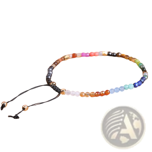 A colorful 7 chakras constellation agate bracelet with gold accents and black cord featuring gemstone beads