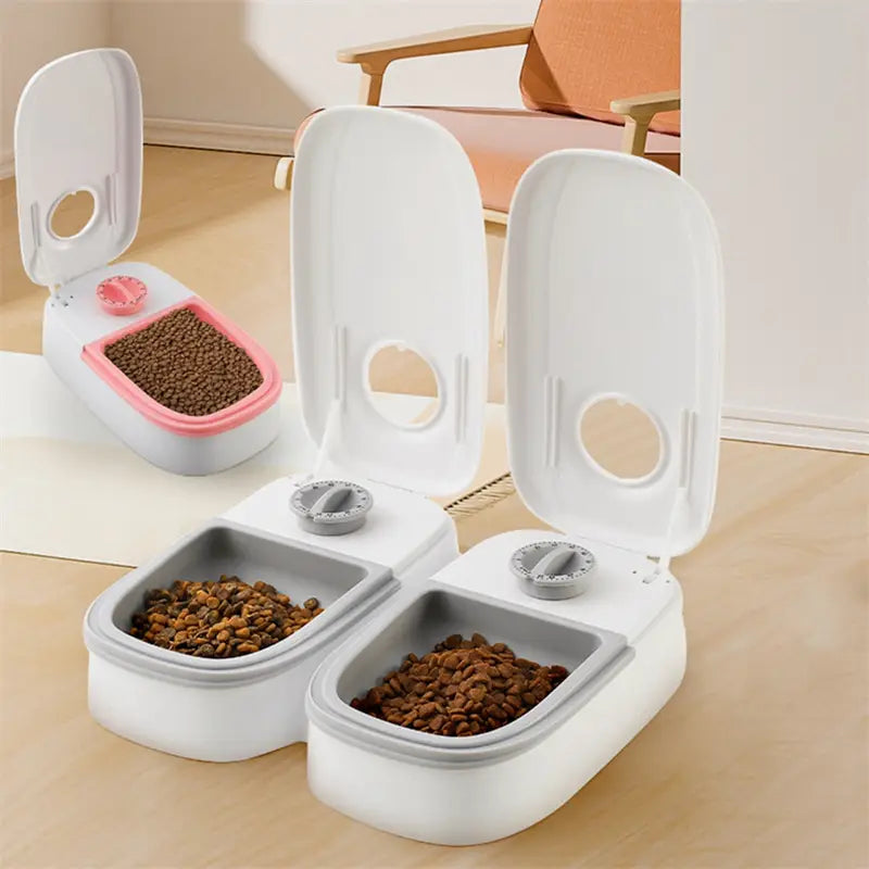 White and gray automatic pet feeders with pink accents featuring hinged lids and adjustable feeding controls for precise food dispensing in an automatic pet feeder gravity waterer and food dispenser.