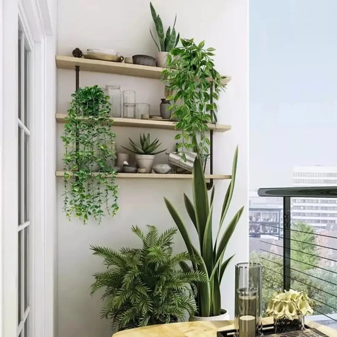 A tall slender artificial hanging snake plant with long upright green leaves in a white ceramic pot from a 3 pack of fake trailing greenery.