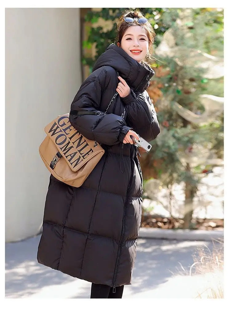 Women long hooded puffer coat in black with quilted design and hood for winter wear.
