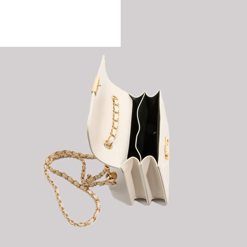 A sleek white leather quilted crossbody bag with a gold-tone chain strap and matching hardware.