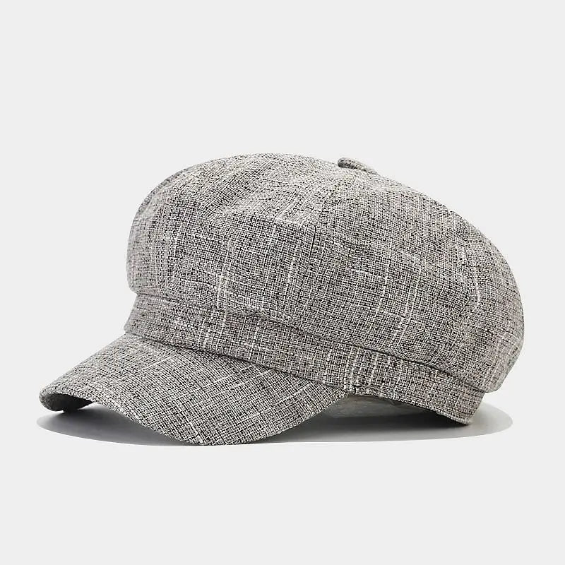 Gray textured British style tweed octagonal newsboy cap for women featuring a subtle plaid pattern and structured brim.
