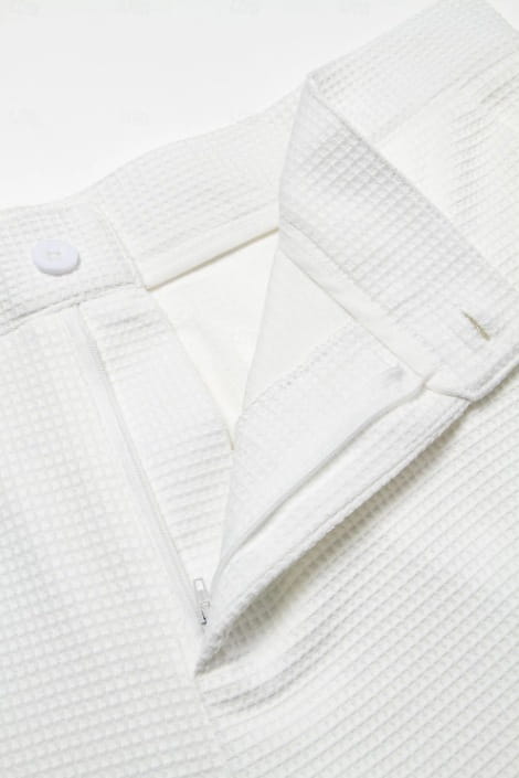 White waffle-knit cotton shirt with a buttoned collar and zipper placket paired with men’s slim fit waffle knit straight leg business trousers.