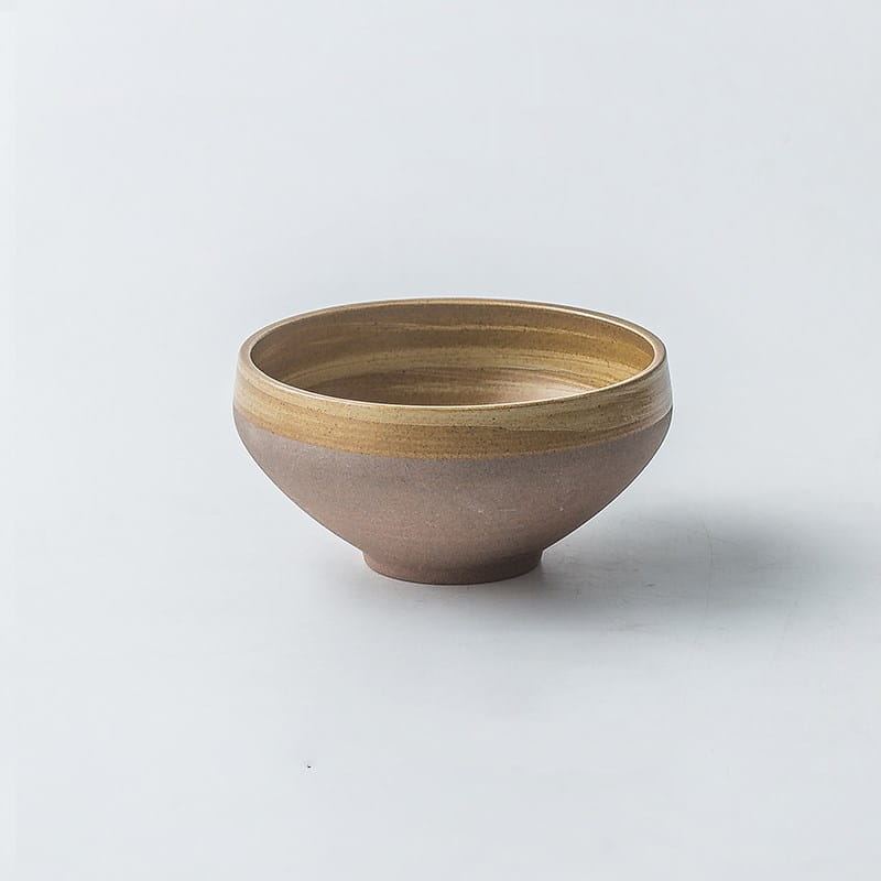 Earthenware bowl from a ceramic tableware set featuring a matte earthy brown exterior and contrasting golden brown rim in retro Japanese dinnerware style.