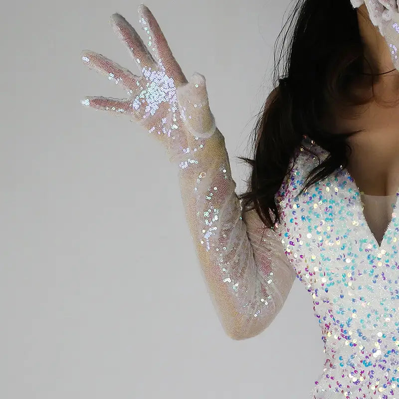 A sheer long-sleeved sequined mesh finger glove set featuring sparkling iridescent sequins that catch the light.