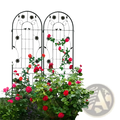 Black wrought iron garden trellis with arched top and floral design supporting red roses for garden use