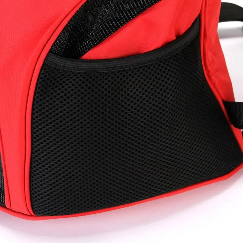 Red and black mesh dog carrier backpack with a breathable ventilated design for small pet travel.