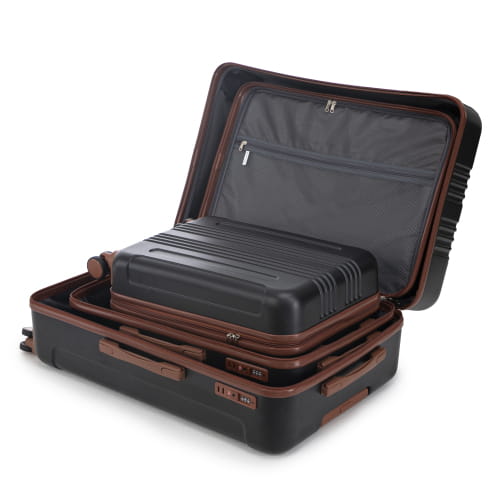 Black and brown hard-shell 3 piece ABS spinner luggage set with textured exterior and leather-like trim on handles and edges featuring TSA lock security.