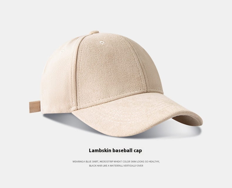 Beige lambskin suede baseball cap with a soft textured finish and adjustable minimalist design featuring a matching fabric tag on the side.