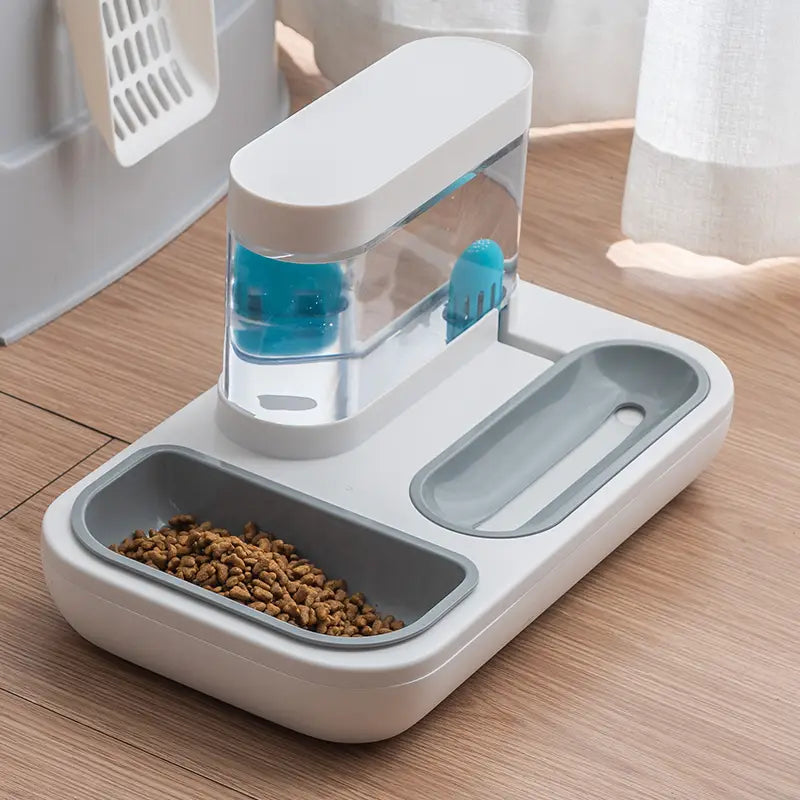 Automatic pet feeder and water dispenser double bowl in white and gray with a clear water reservoir showing blue internal components for convenient pet feeding and hydration.