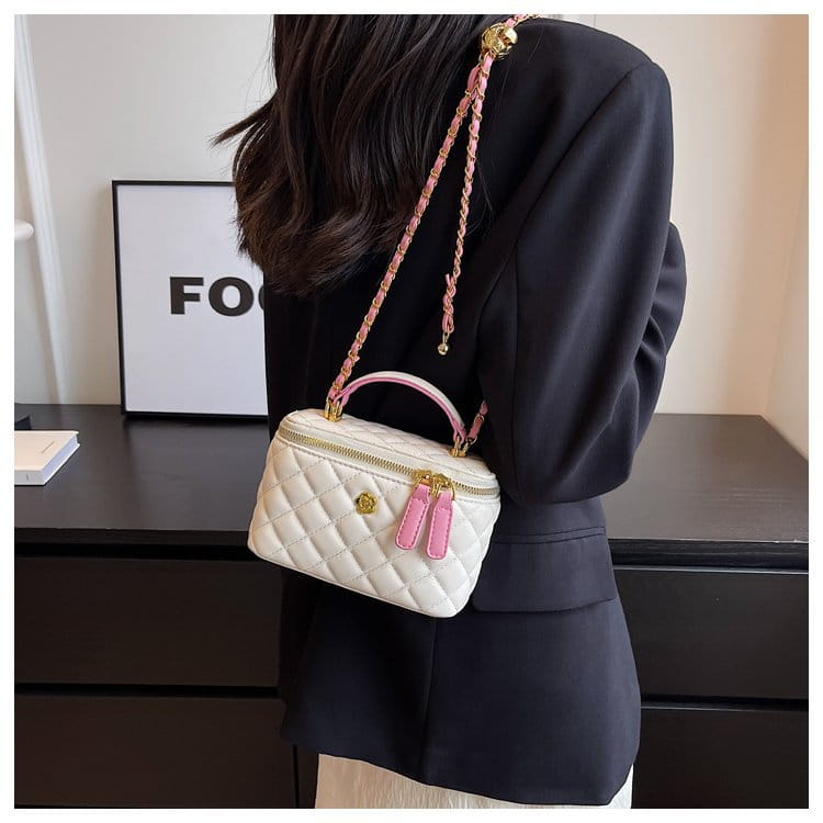 White quilted diamond chain crossbody bag with pink pu leather handles and gold-tone hardware accents.