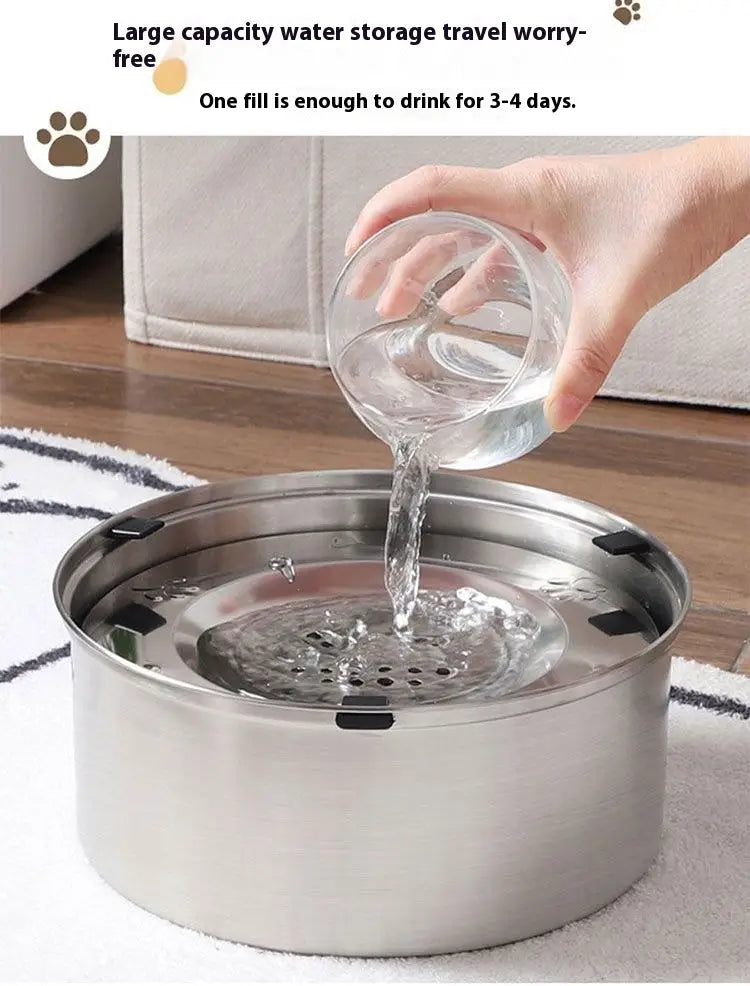 Large stainless steel pet water bowl with perforated base and black rubber seals for durable and hygienic hydration.