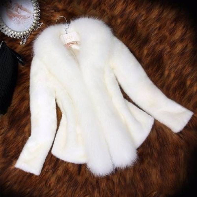 A plush white padded coat with a voluminous faux fur collar and long sleeves hanging on a hanger designed as a slim winter jacket for women.