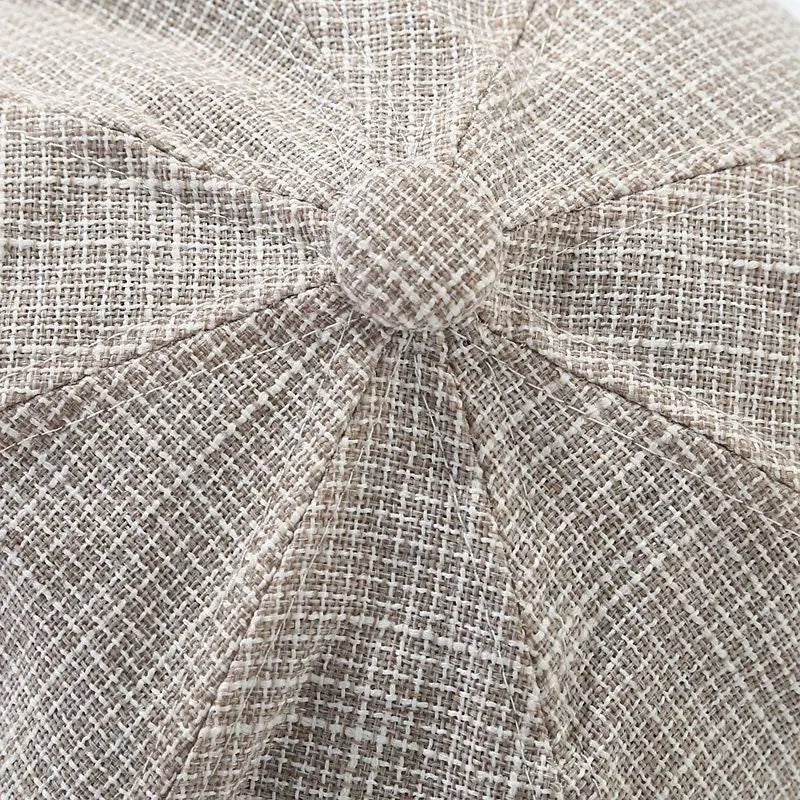 Beige tweed octagonal cap for women featuring a textured woven pattern and a matching button at the center in british style.