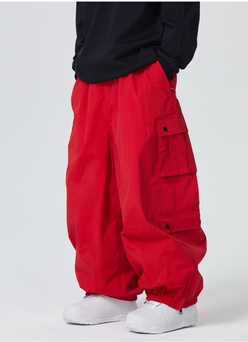 Bright red loose-fitting winter outdoor ski pants with multiple cargo pockets and a drawstring waistband.