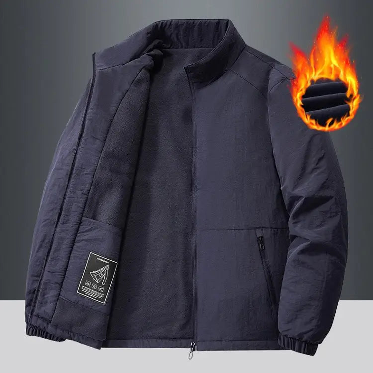Dark navy quilted fleece sports jacket with stand collar, front zipper, ribbed cuffs, and waistband.