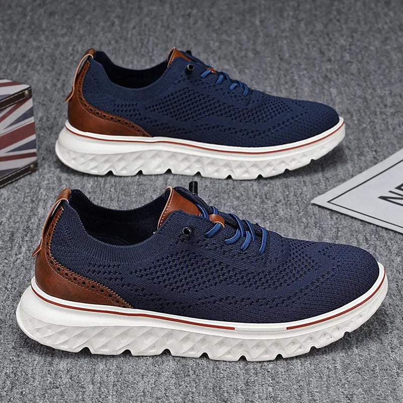 Men’s mesh knit casual lightweight sneakers in navy blue with brown leather accents and a white rubber sole.