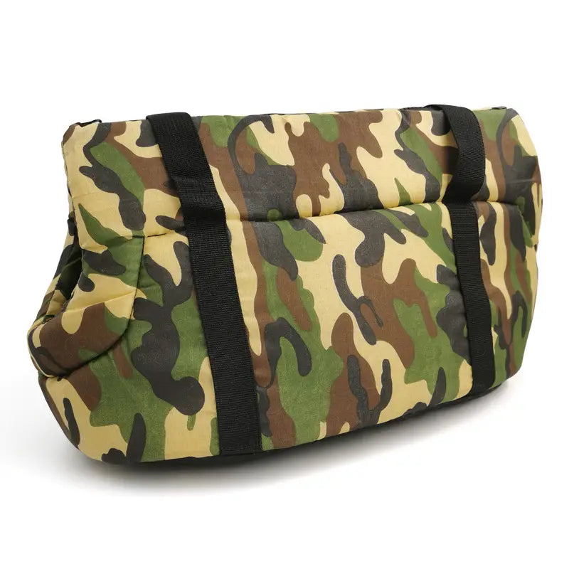 Camouflage-patterned warm pet carrier made of canvas and fleece with padded design and black straps for travel.
